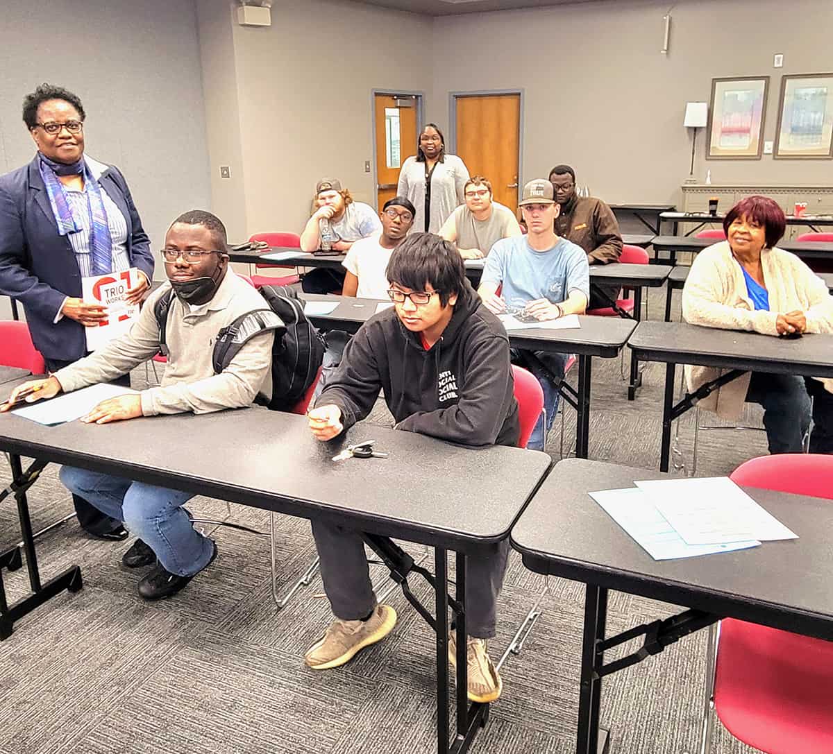 Valerie Hicks (standing, left) of the Mercer University Educational Opportunity Center taught students about financial literacy in a recent workshop at the South Georgia Technical College Crisp County Center.