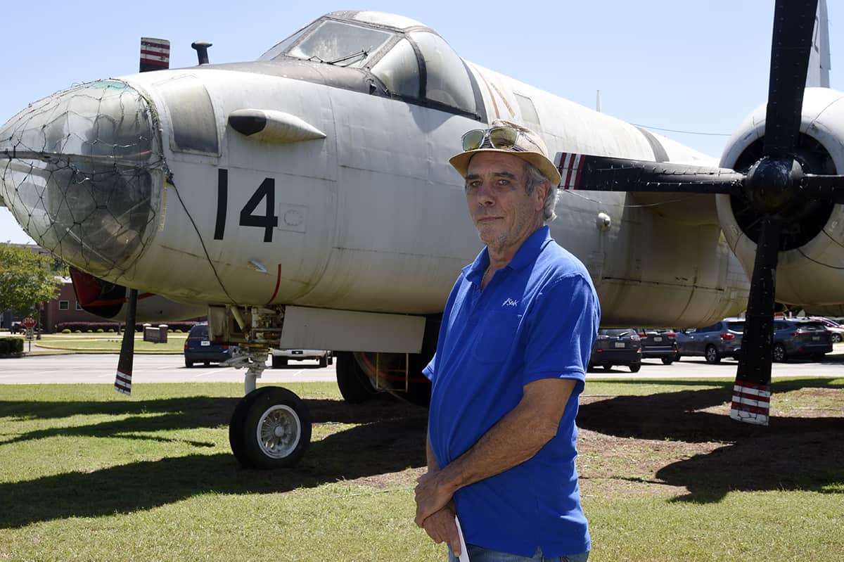 1990 South Georgia Tech aviation graduate Scott Schneider stands in front of the college’s World War II-era Navy Lockheed P2V-7 Neptune airplane during a recent visit to the SGTC campus.