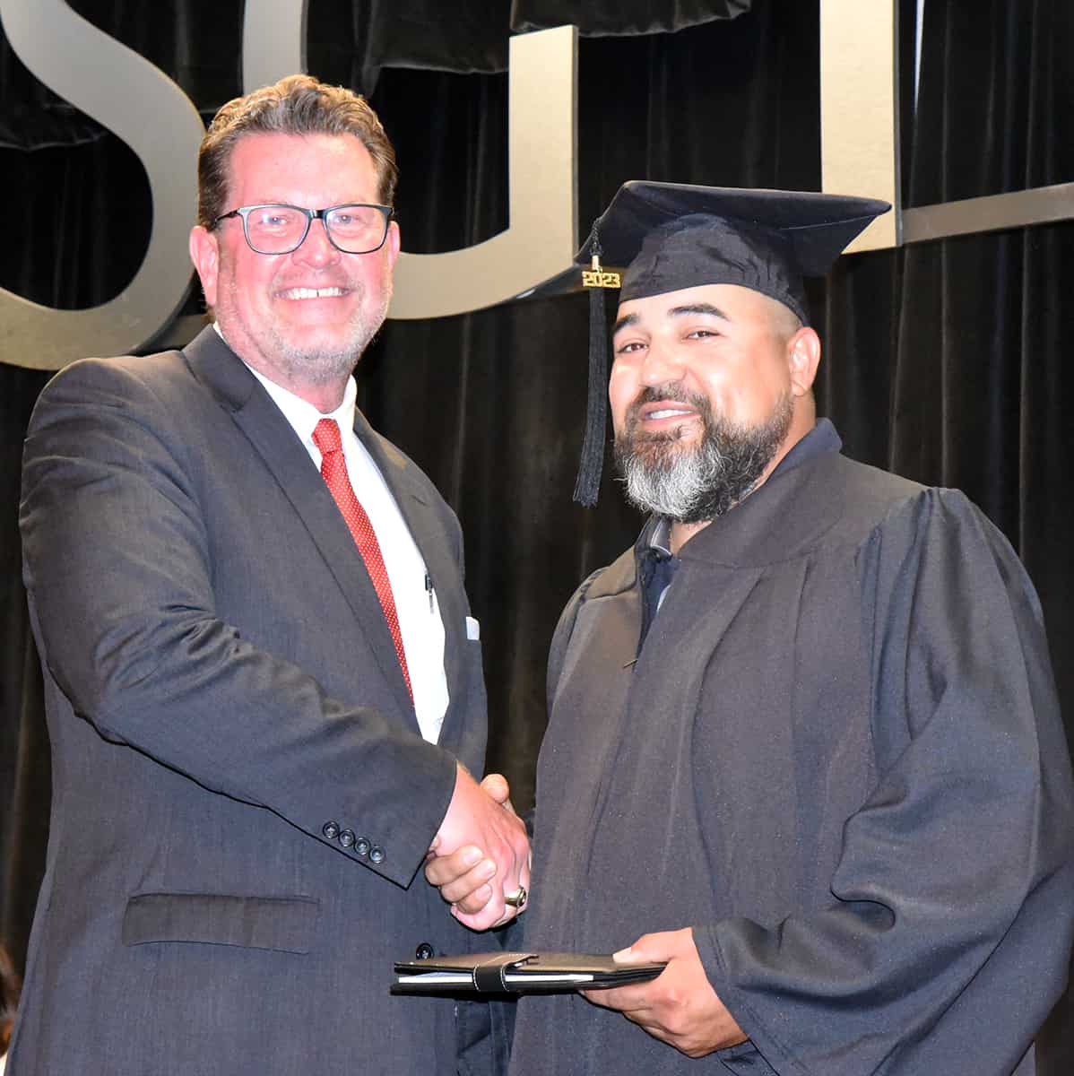 Roger Lopez, a 2023 SGTC High School Equivalency graduate, was the guest speaker at the graduation ceremony and he is shown above receiving his diploma from SGTC President Dr. John Watford.