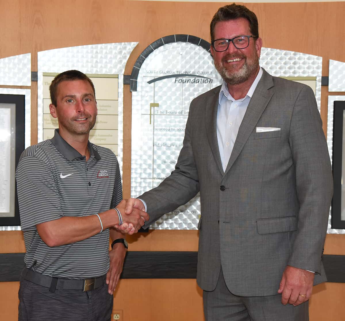 SGTC President Dr. John Watford (r) is shown above with new SGTC Athletic Director and Lady Jets head coach Jason Carpenter (l).