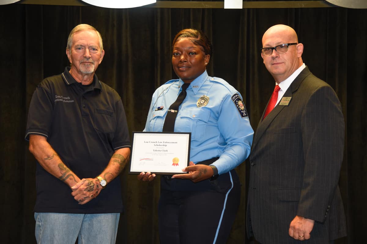 Takeita Clark of the South Georgia Technical College Law Enforcement Academy Class 23-02 is shown above (ceter) receiving the SGTC Foundation Lou Crouch Law Enforcement Academy Scholarship award. Lou Crouch (left) and SGTC Law Enforcement Academy Director Brett Murray are also shown.