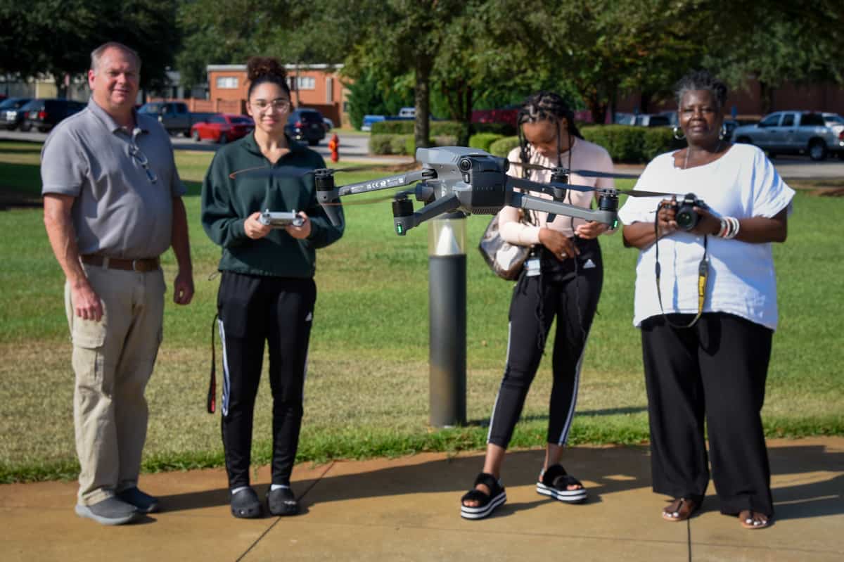 SGTC Marketing instructor Mary Cross (right) and her students recently received a demonstration of drone technology from Electronics and Unmanned Aerial Systems Technology instructor Mike Collins (left).