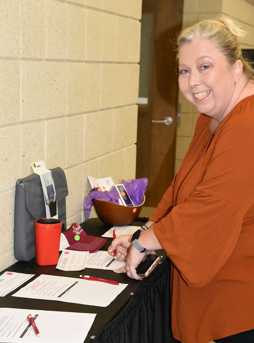 SGTC Foundation’s 2023 Internal Techforce Employee Luncheon and Silent Auction Chairperson Teresa McCook is shown above bidding on items at the 2019 TechForce Silent Auction internal fund drive.