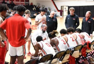 Coach Chris Ballauer is talking to Jets during timeout.
