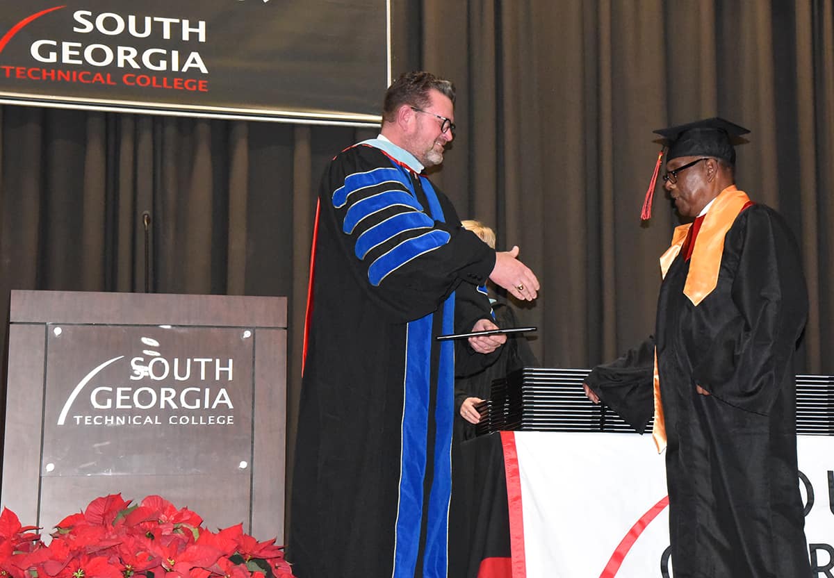 South Georgia Technical College President Dr. John Watford (left) is shown above presenting Ernest Calvin Mansfield of Americus, a Presidential Honor Graduate with his Associate Degree in Criminal Justice.