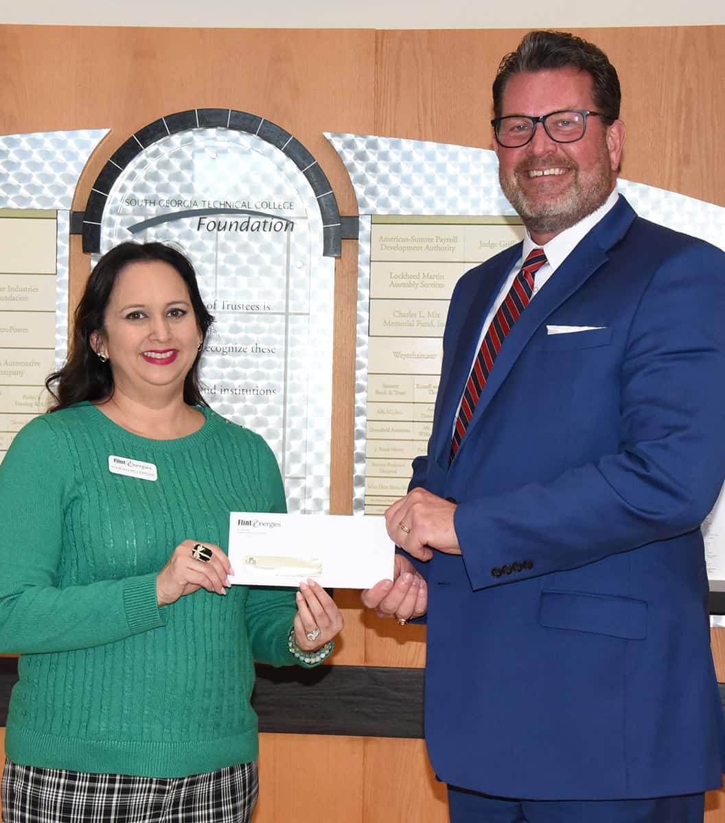 South Georgia Technical College President Dr. John Watford, (r), is show above accepting a donation for the SGTC Foundation from Marian McLemore, (l) Vice President of Cooperative Communications with Flint Energies.