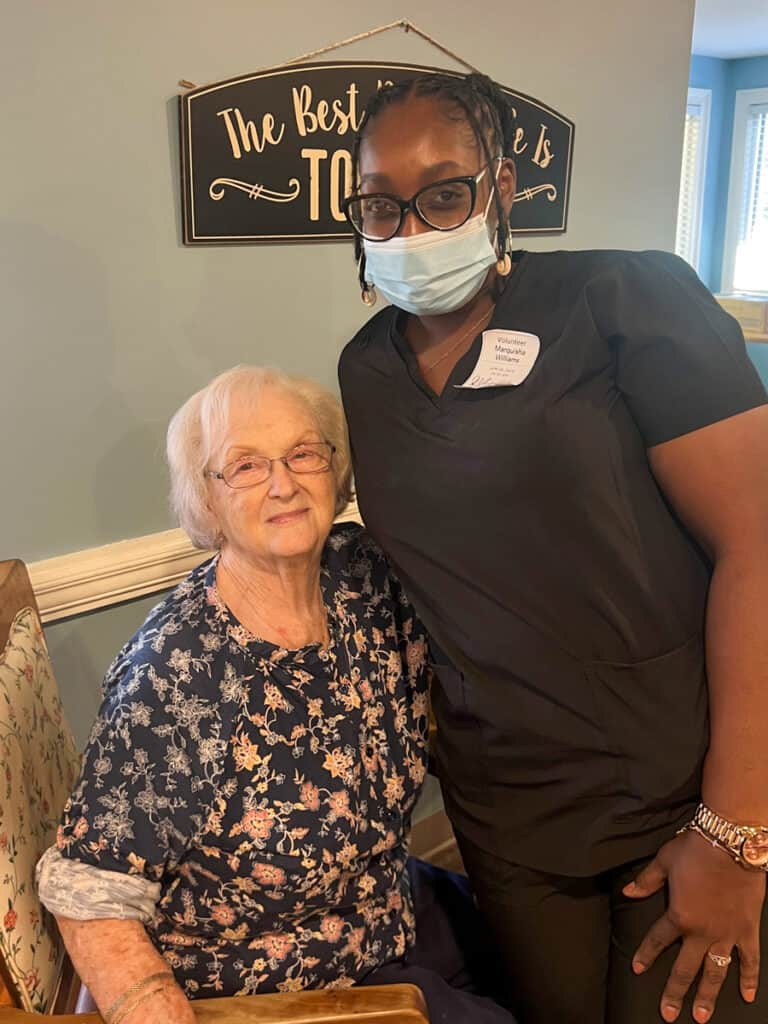 A Nail Tech student from SGTC works with a resident at Magnolia Manor.