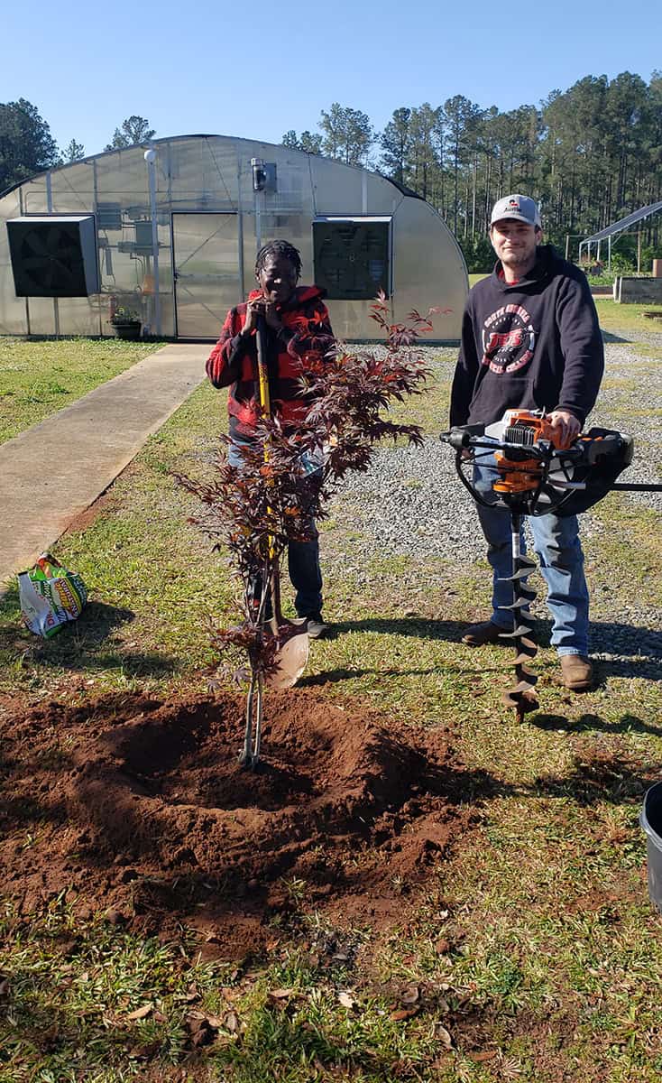 SGTC Horticulture students Kyle Davis and Lisa Sellars are shown above planting the Japanese Maple tree on the SGTC campus in honor of Earth Day.