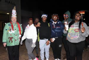 SGTC Culinary Arts Instructor Chef Ricky is shown above with some of his students passing out goodies to all the cars.