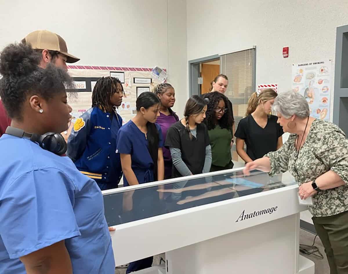 SGTC Medical Assisting Instructor Carol Cowan is shown above showing the Crisp County High School Health Occupations students the colleges new anatomage digital table that they use in the medical programs to show all facets of the human body.