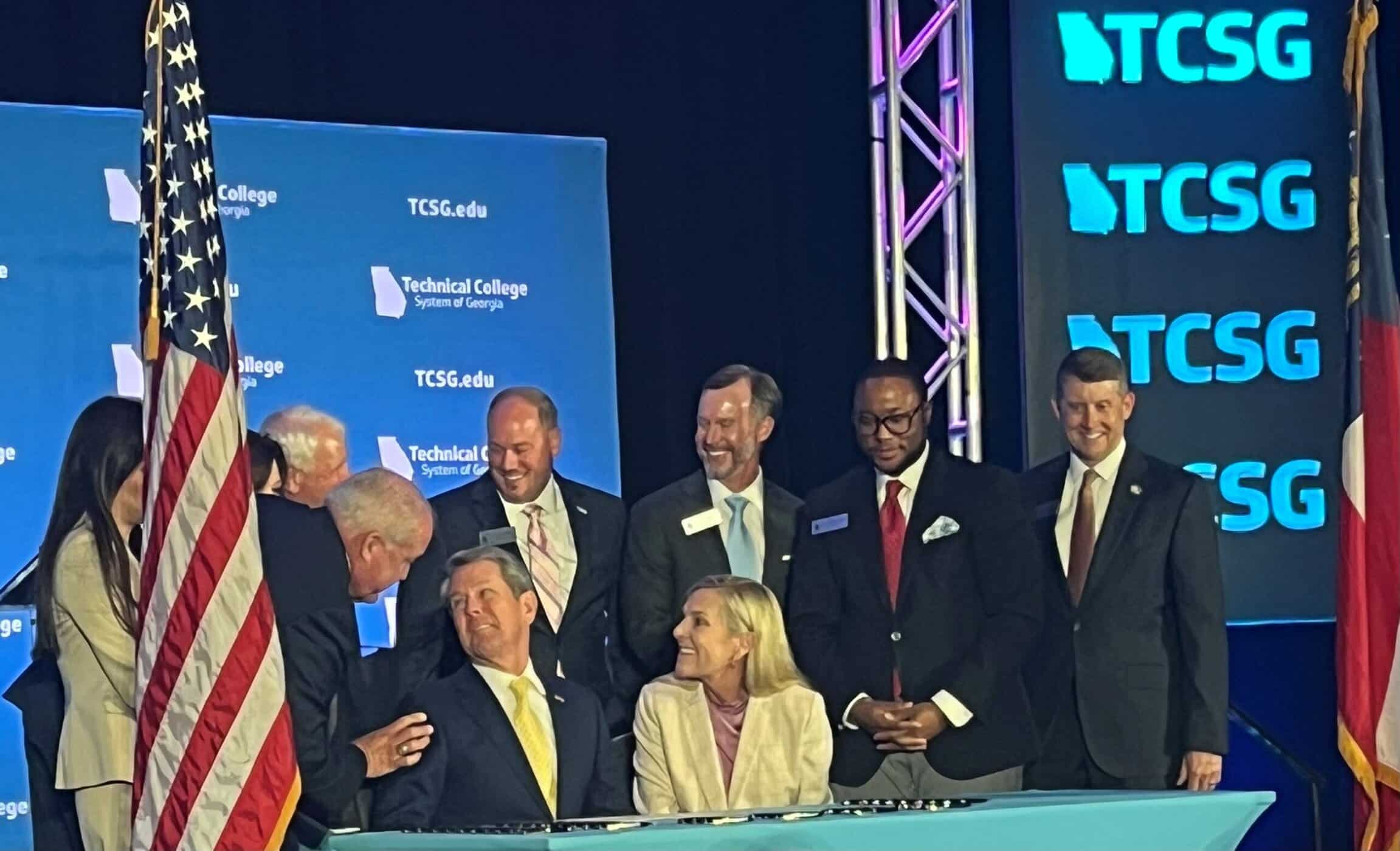 Georgia Governor Brian Kemp is shown above signing bills at the TCSG Leadership Conference.