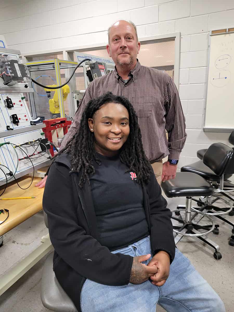 SGTC Industrial Systems Technology student Dy’Ashia McCoy (seated) with instructor Patrick Owen.
