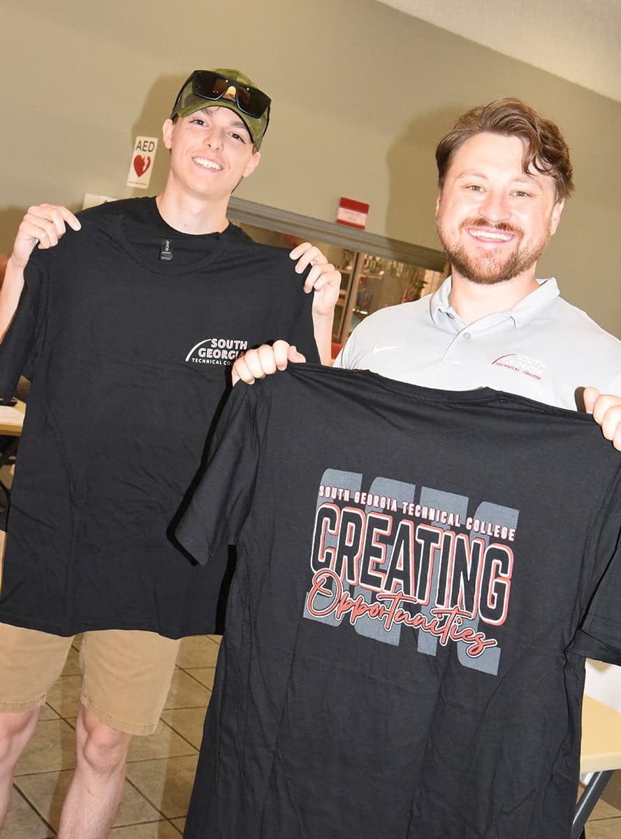 Free “Creating Opportunities” t-shirts will be available to students registering for Fall Semester at South Georgia Technical College while supplies last. In-person registration will be held August 13, 2025 in Americus and Crisp County. Shown above (l to r) are SGTC student affairs recruiter Tylen Pepito and a students already signed up for Fall Semester showing off the new SGTC “Creating Opportunities” t-shirts.
