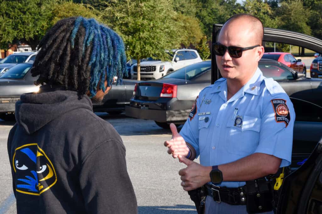 Trooper First Class II Danny Nguyen of Georgia State Patrol Post 10 in Americus speaks to a South Georgia Technical College student about the role of a state trooper in law enforcement.