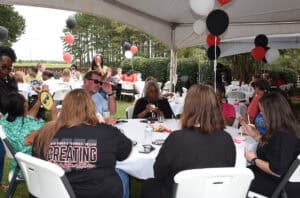 SGTC President Dr. John Watford is shown above sitting with faculty and staff during the SGTC Employee Celebration event.