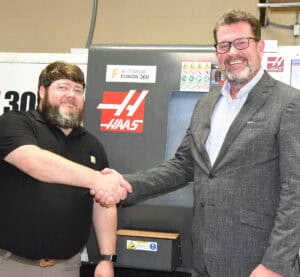 South Georgia Technical College President Dr. John Watford (right) is shown above with SGTC Precision Machining and Manufacturing Instructor Jake Pittman congratulating him on the Gene Haas Foundation donation to the SGTC Foundation that will ultimately help his students and program.