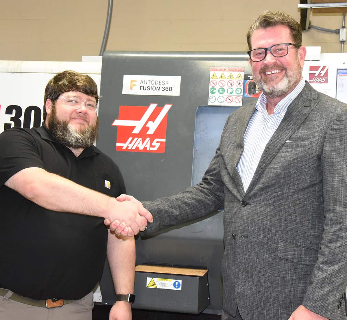 South Georgia Technical College President Dr. John Watford (right) is shown above with SGTC Precision Machining and Manufacturing Instructor Jake Pittman congratulating him on the Gene Haas Foundation donation to the SGTC Foundation that will ultimately help his students and program.