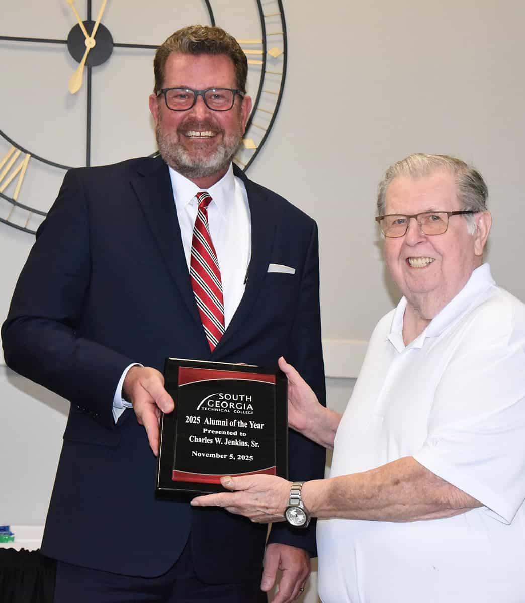South Georgia Technical College President Dr. John Watford is shown above presenting a token of appreciation from the college to SGTC Alumnus of the Year Charles Jenkins for his outstanding achievements in the field of practical nursing.