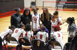 SGTC Lady Jets head coach Jason Carpenter talks with his team during a timeout.