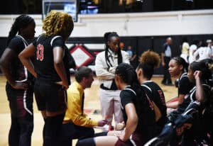 SGTC Lady Jets coach Jason Carpenter talks with team during a timeout.