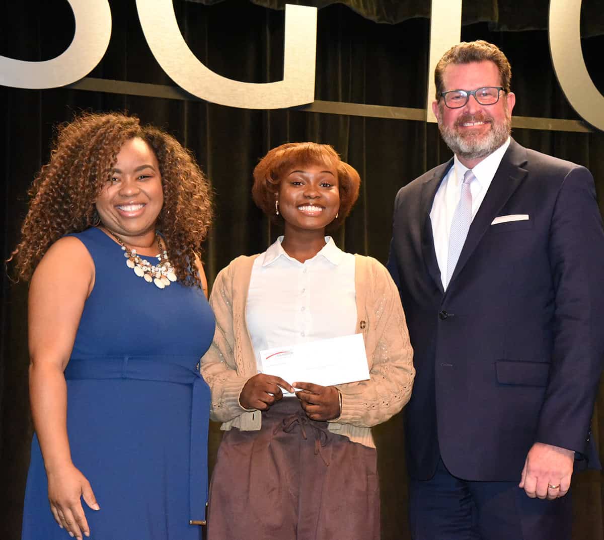 Amber Batchelor of Batchelor & Bradley Insight Group, LLC (l) is shown above presenting a check to Keyara Williams (c), who was selected as the SGTC 2026 GOAL student of the year. SGTC President Dr. John Watford (r) is also shown congratulating Williams and thanking Batchelor for her support.