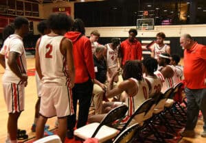 Jets head coach Chris Ballauer talks with team during a timeout.