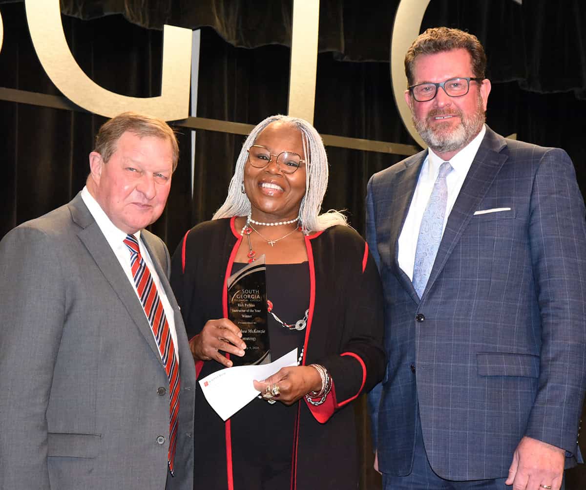 Synovus’ Emory Parker (left) is shown above presenting Dorothea McKenzie with a donation from Synovus for being selected as the South Georgia Technical College 2025 Rick Perkins Instructor of the Year. SGTC President Dr. John Watford is also shown congratulating McKenzie on her honor.