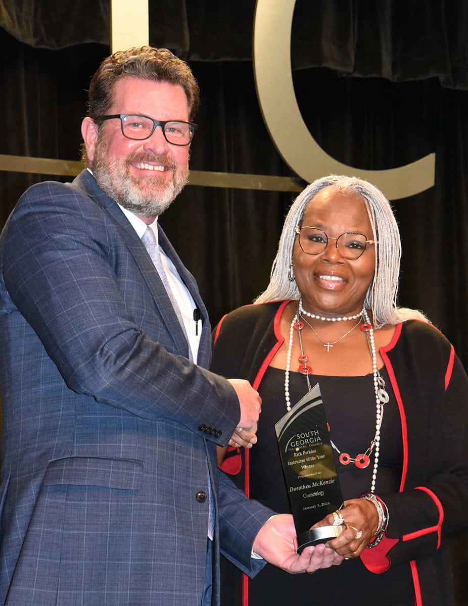 SGTC President Dr. John Watford (left) presents Dorothea Lusane McKenzie with the 2026 Rick Perkins Instructor of the Year award.