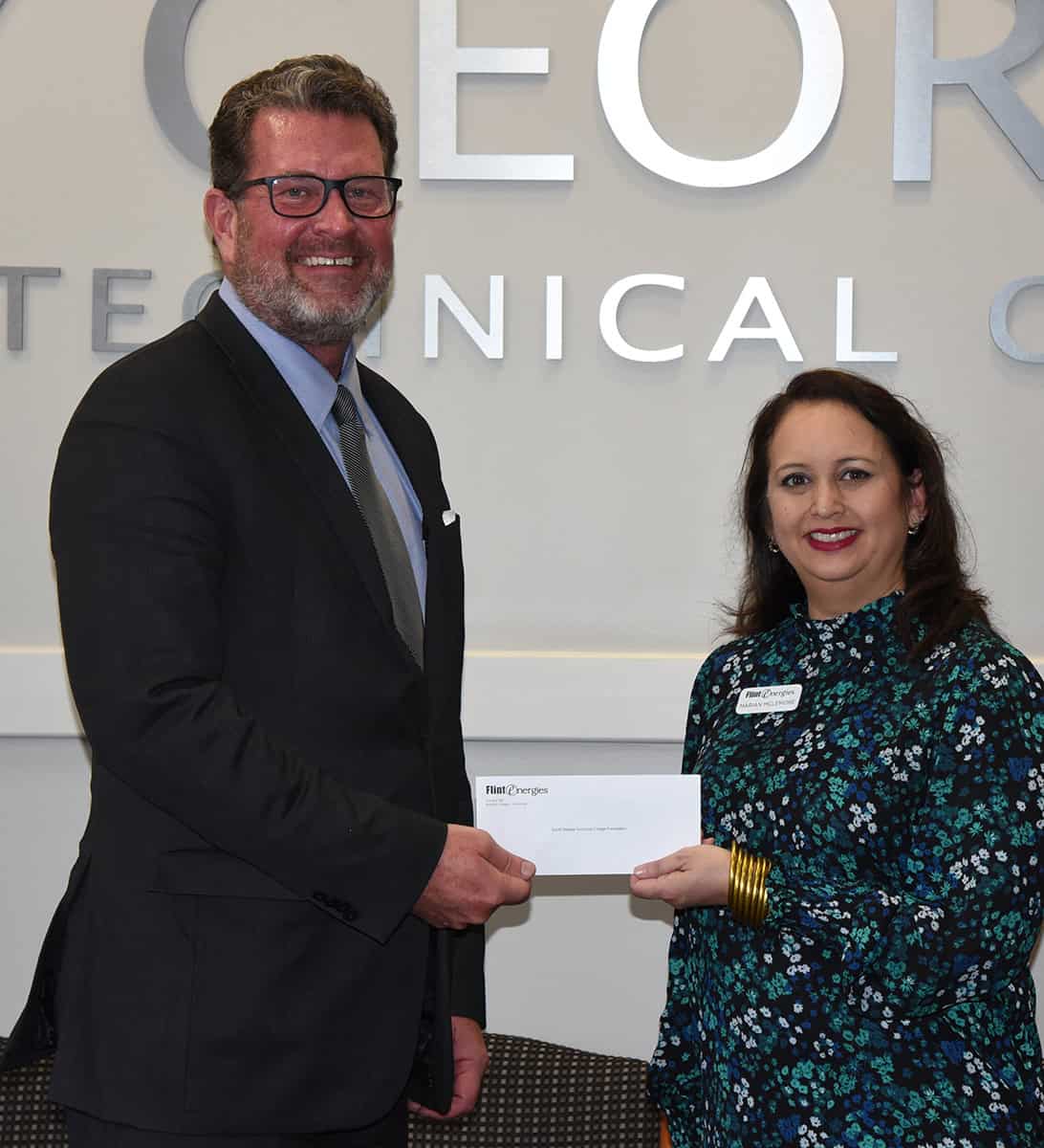 South Georgia Technical College President Dr. John Watford, (l), is shown above accepting a donation for the SGTC Foundation from Marian McLemore, (r) Vice President of Cooperative Communications with Flint Energies.