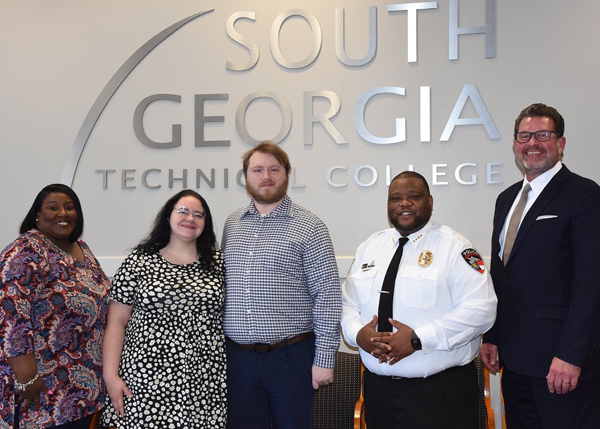 SGTC President Dr. John Watford (right) is shown above with SGTC Police Chief Calvin Hodge (second from right) along with Matthew Perrine and his wife, Melissa, and SGTC Vice President of Student Affairs Eulish Kinchens who participated in the swearing in ceremony for Officer Perrine.